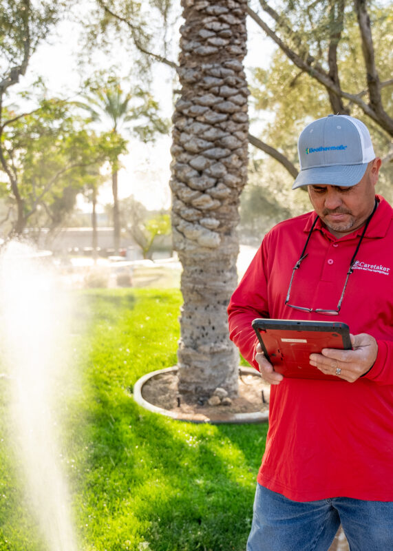 Irrigation technician onsite looking at SmartLink app on his tablet