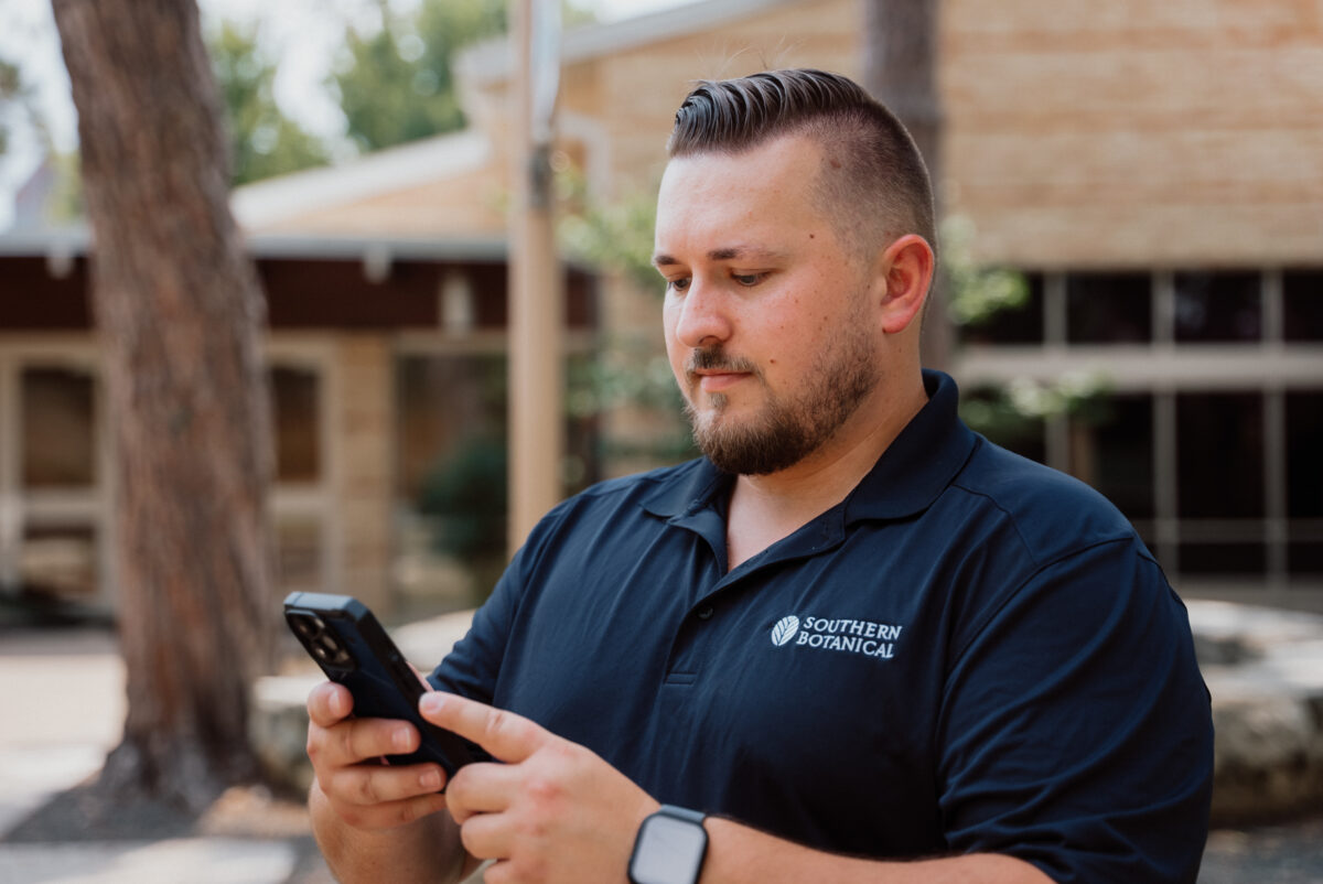 Man looking at phone on a job site