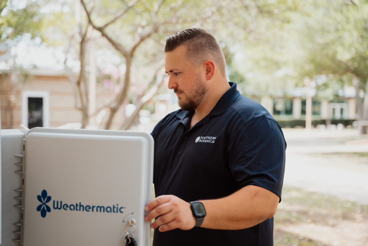 Technician in the field adjusting the Weathermatic hardware