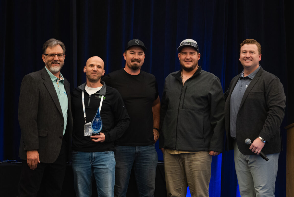 Group of 5 men smiling at camera at SmartCon 2024 conference