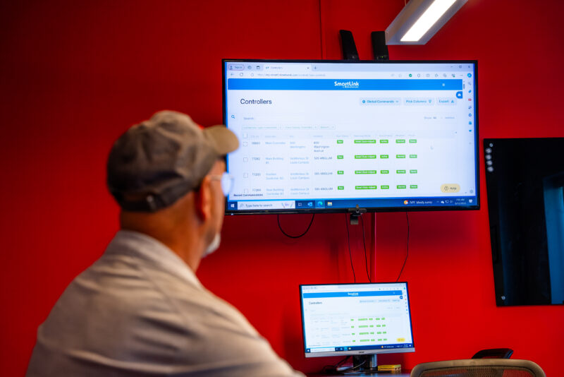 Irrigation Tech in the office viewing his SmartLink dashboards